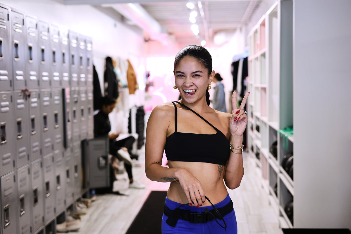 yoga instructor giving a peace sign in the studio at the barre code